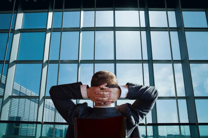 businessman boss of the company relaxing and looking at the window