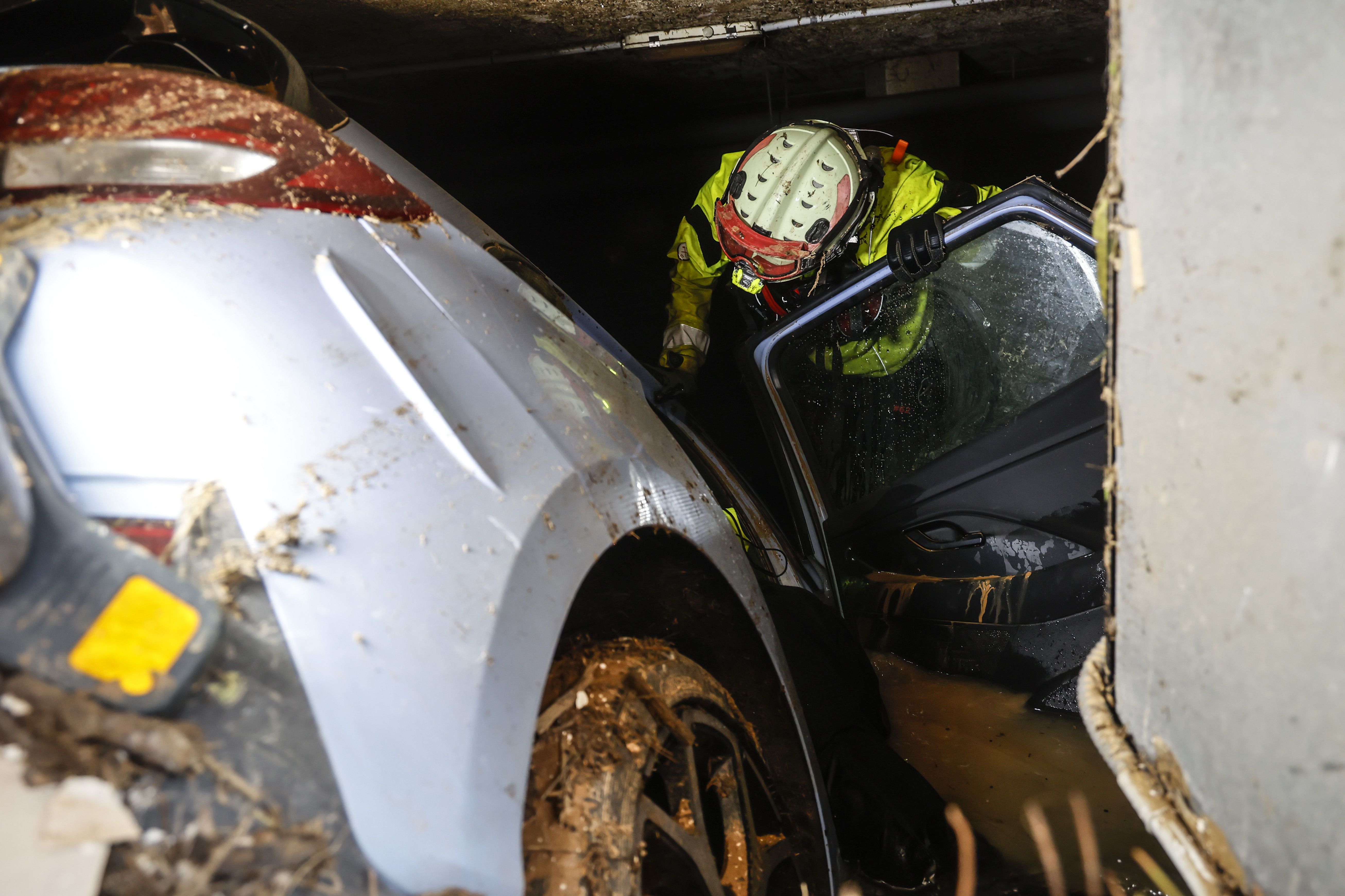 Bombero inspeccionando un coche en uno de los garajes afectados por la DANA, en Alfafar (Valencia) a 2 de noviembre de 2024 | Foto: Rober Solsona/Europa Press